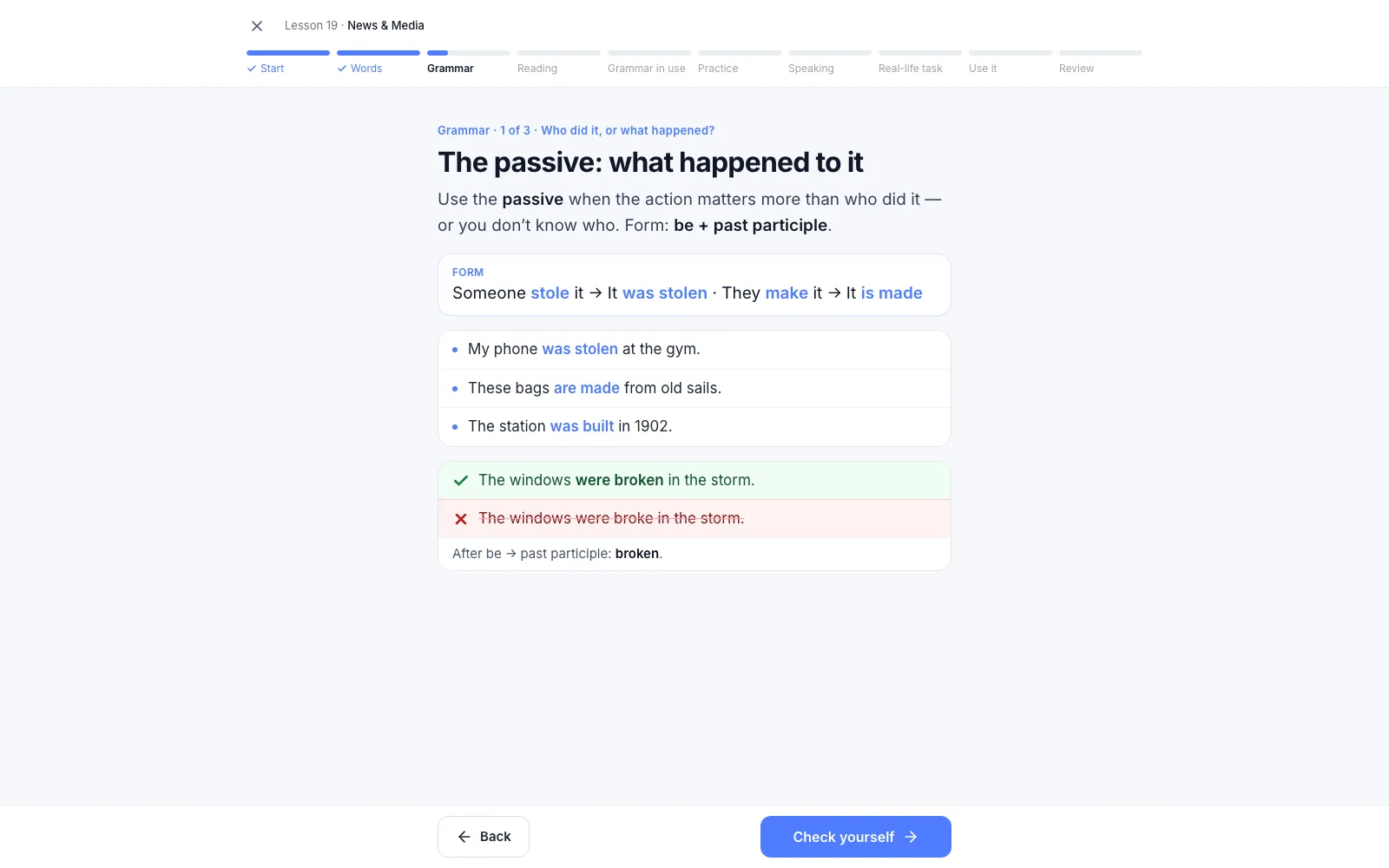 The passive grammar step of Fluentra's B1 lesson News & Media: someone stole it becomes it was stolen, with The windows were broken in the storm marked right and were broke marked wrong